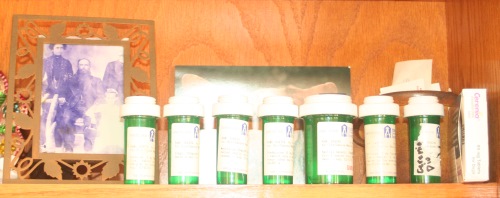 Dio’s pharmacy; for a little extra help, I kept the pills next to a photo of my Greek grandma when she was little, because her own love for and rescues of animals is one of the reasons I can't resist them either / Photo: Katerina Lorenzatos Makris